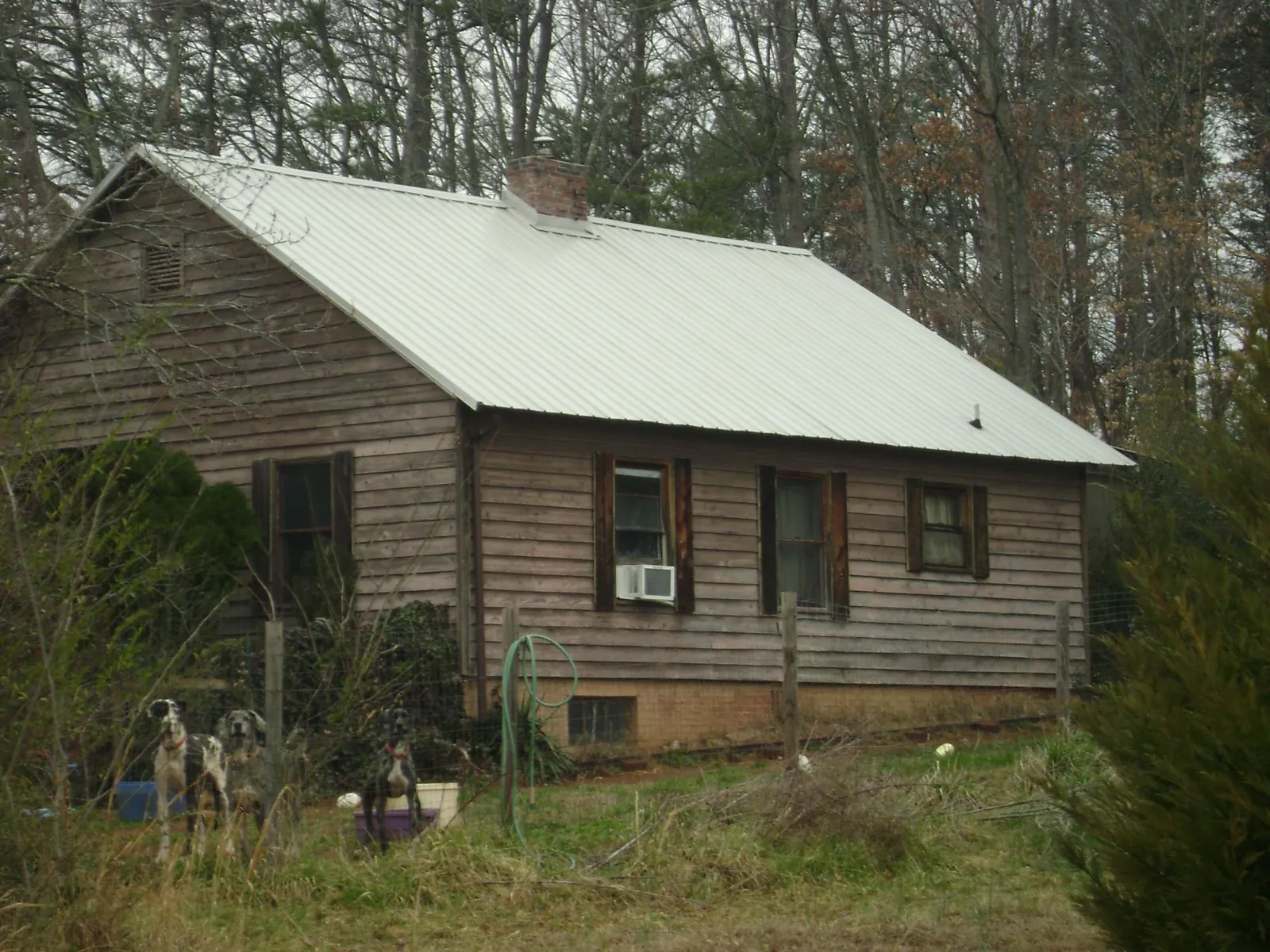 White metal roof on an old wood sided farmhouse, from a Metal Roof Installation job in McCall